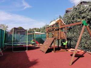 a playground with a slide and a swing set at Szárszó Holiday Apartman in Balatonszárszó