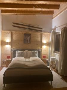 Schlafzimmer mit einem großen Bett und Holzwänden in der Unterkunft Apart Alps & Nature in See