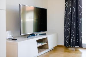 a flat screen tv sitting on top of a white cabinet at Ferienwohnung Modi in Gamlitz