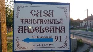 a sign on the side of a road at Casa Traditionala Ardeleana in Mădăras