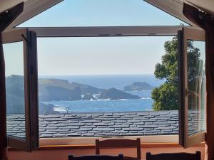 a large window with a view of the ocean at Casa Tésera in El Franco