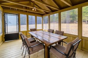 a dining room with a wooden table and chairs at L'OASIS DU MASSIF - Spa, BBQ, foyer et plaisir ! in Saint-Paul-de-Montminy
