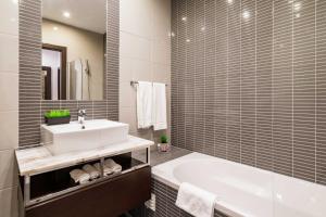 a bathroom with a white sink and a tub at ALBUFEIRA (OLD TOWN) VERASOL AA - THE LUXURY STAY in Albufeira +34 photos
