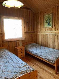 Postel nebo postele na pokoji v ubytování Domek Green Dźwirzyno