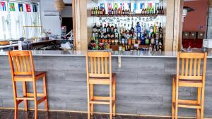 duas cadeiras sentadas em frente a um bar em Hyannis Plaza Hotel em Hyannis