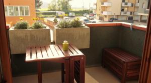 a balcony with a bench and a view of a city at Conero Green Homes in Porto Recanati