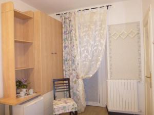 a room with a curtain and a chair and a window at Affittacamere Monica in Monterosso al Mare