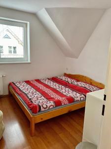 a bed sitting in a room with a window at Chalupa Synka in Terchová
