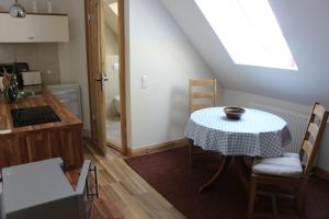 a small kitchen with a table and a window at landhaus rosmarin in Oschersleben