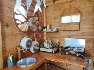 a kitchen with a counter with a stove and a mirror at Dream catcher treehouse in Preveza
