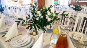 a white table with a vase of flowers on it at Jaszowianka Best For You in Ustroń