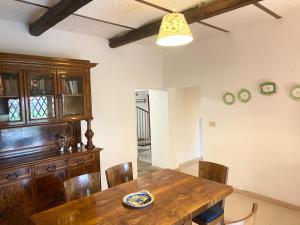 a dining room with a wooden table and chairs at Adamasseria in Collecorvino