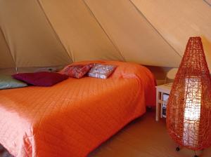 a bedroom with a bed in a tent at Terre del Piano-Bell Tent in Corinaldo
