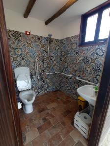a bathroom with a toilet and a sink at Terre del Piano-Bell Tent in Corinaldo