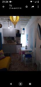 a kitchen with a table and a dining room at Alojamiento con encanto in Vejer de la Frontera