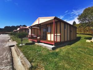 a small house on the side of the road at Bungalow As Nevedas in Carballo