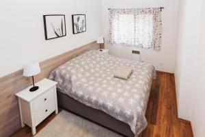 A bed or beds in a room at Vila Olívia - Apartmán Olívia 1