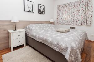 A bed or beds in a room at Vila Olívia - Apartmán Olívia 1