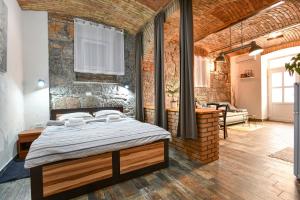 a bedroom with a bed and a brick wall at Apartment Rosenberger, Opatija center with parking in Opatija
