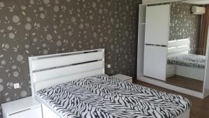 a bedroom with a bed with a zebra print wall at Villa Princess Maria in Balchik