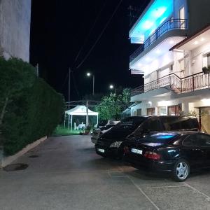 
a car parked on the side of a street next to a building at Hotel Drosia in Messini
