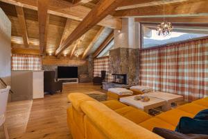 a living room with a couch and a fireplace at Chalet SNOW in Demanovska Dolina
