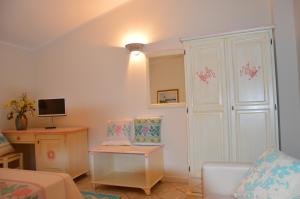 a living room with a white cabinet and a couch at Hotel La Palma in San Teodoro