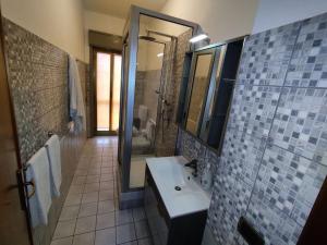 a bathroom with a sink and a shower and a mirror at Casa Vacanza SalGiò in Riposto