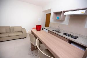 a kitchen with a counter and a couch in a room at Alta Vista Thermas Resort in Caldas Novas