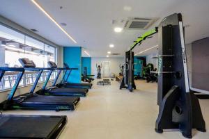 a gym with a row of treadmills and machines at OLIMPIA PARK RESORTs "MELHOR PREÇO " in Olímpia