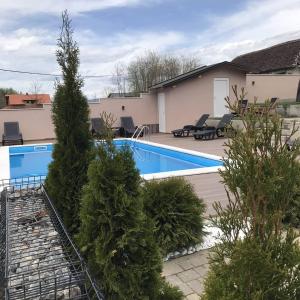 a house with a swimming pool and some trees at Drinska Idila apartmani in Vrhpolje