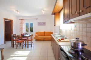 a kitchen and living room with a couch and a table at Liotrivi Studios in Vasiliki