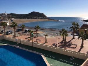 a view of a resort with a swimming pool and a beach at Apartamento en Residencial La Isla in Puerto de Mazarrón