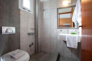 a bathroom with a sink and a toilet and a mirror at Liotrivi Studios in Vasiliki +49 photos