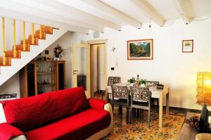a living room with a red couch and a table at Morgana in Casarano