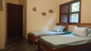 Lova arba lovos apgyvendinimo įstaigoje Casa aconchegante em Guaeca - 8 pessoas
