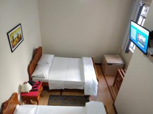 Postel nebo postele na pokoji v ubytování Hotel Cervantes
