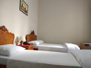 Postel nebo postele na pokoji v ubytování Hotel Cervantes