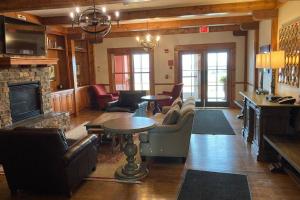 a living room with furniture and a fireplace at 'The Treehouse' at Snowshoe - Village & Slope View in Snowshoe