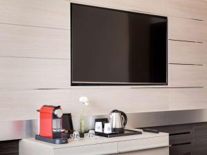 a kitchen with a microwave and a coffee maker at Novotel Brescia Due in Brescia