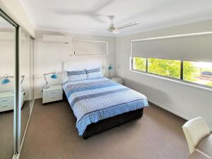 a bedroom with a bed and a window at Lillypilly Resort Apartments in Rockhampton