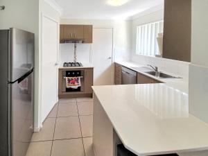 a kitchen with a white counter top and an oven at Lillypilly Resort Apartments in Rockhampton