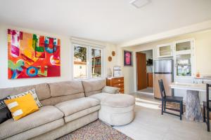 a living room with a couch and a kitchen at Serene by the Sea in Savaneta