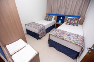 En eller flere senger på et rom på Alta Vista Thermas Resort