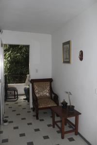 een woonkamer met een stoel en een tafel bij Hospedaje Primavera in Medellín