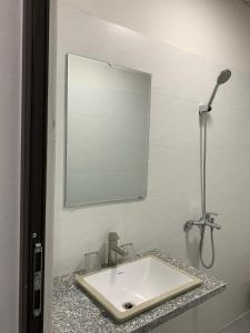 a bathroom with a sink and a mirror at 58M Motel in Cao Bằng