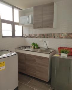 a kitchen with a sink and a counter top at CASA AVILA - Apartamento amoblado 1 - Villa Alsacia in Bogotá