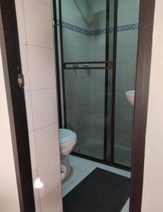 a bathroom with a toilet and a glass shower at CASA AVILA - Apartamento amoblado 1 - Villa Alsacia in Bogotá