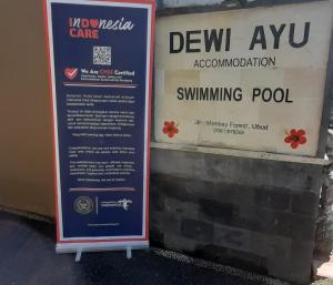 a sign on the side of a building at dewi ayu accomodation in Ubud
