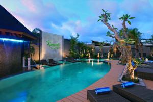 a swimming pool at a hotel with a resort at Kamuela Villa Lagoi Bay Bintan in Lagoi